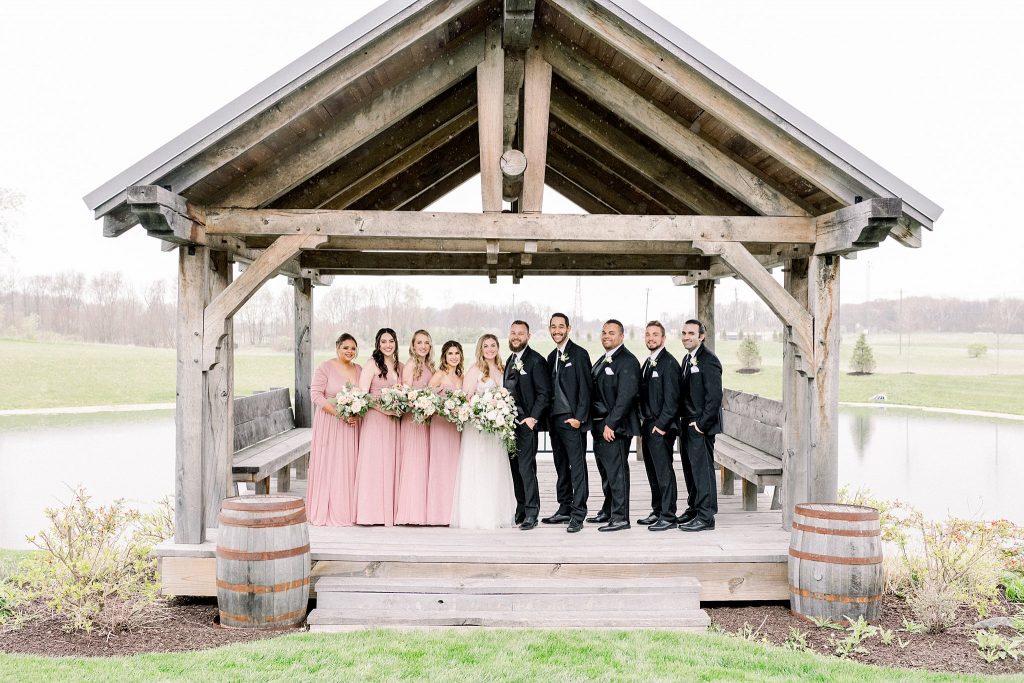 Bridal Party standing on deck at Lindley Farmstead at Chatham Hills