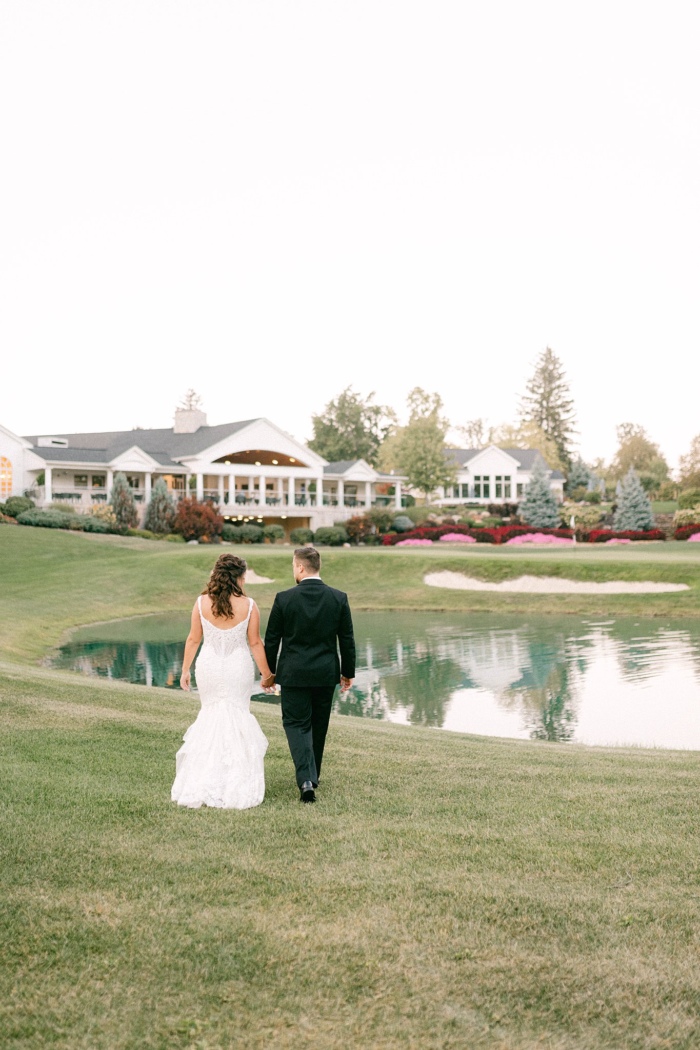 Bride and groom walking toward reception during elegant Sycamore Hills Wedding in Fort Wayne