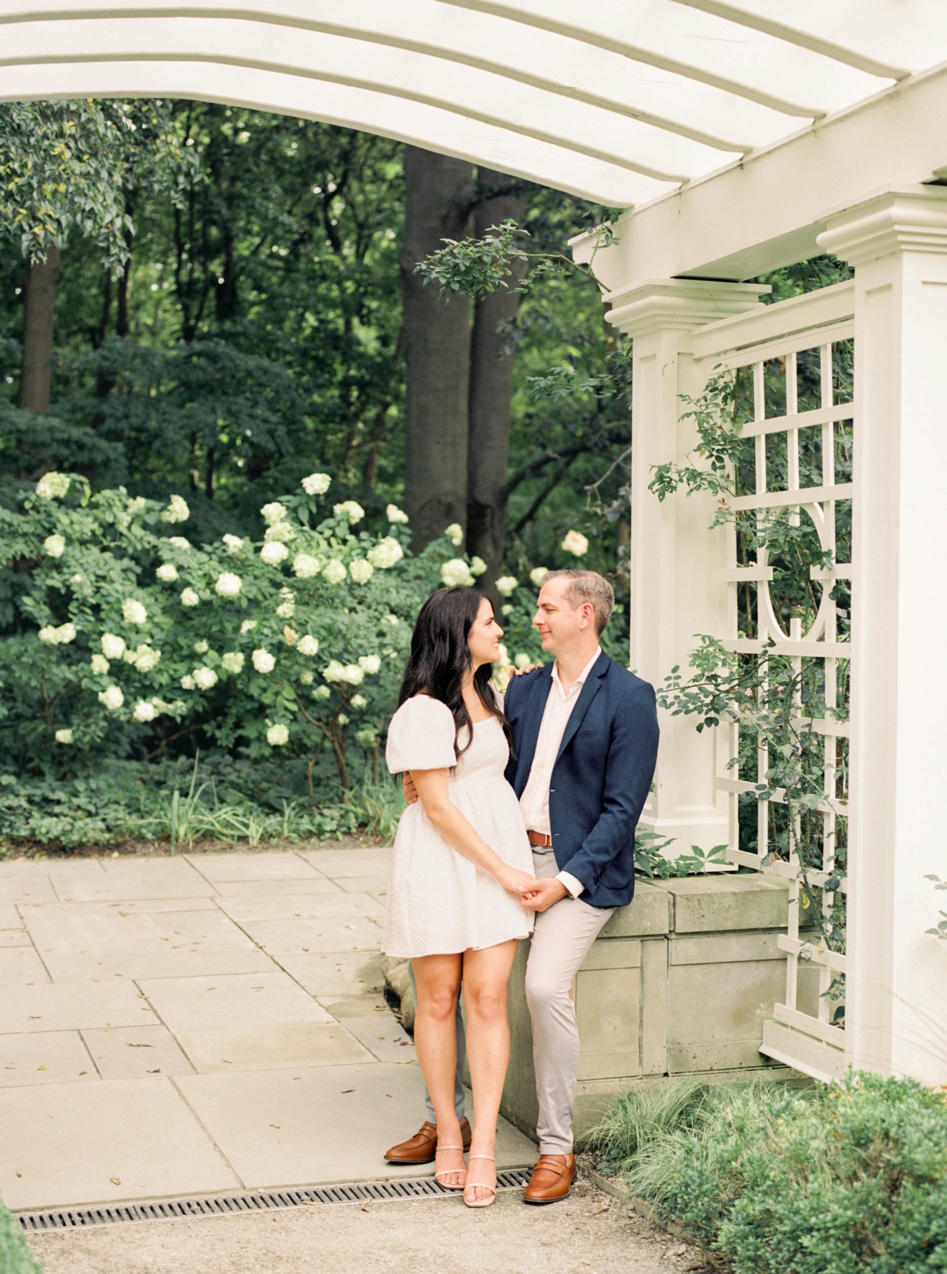 Couple walk hand in hand through garden at Newfields Engagement Session on Film