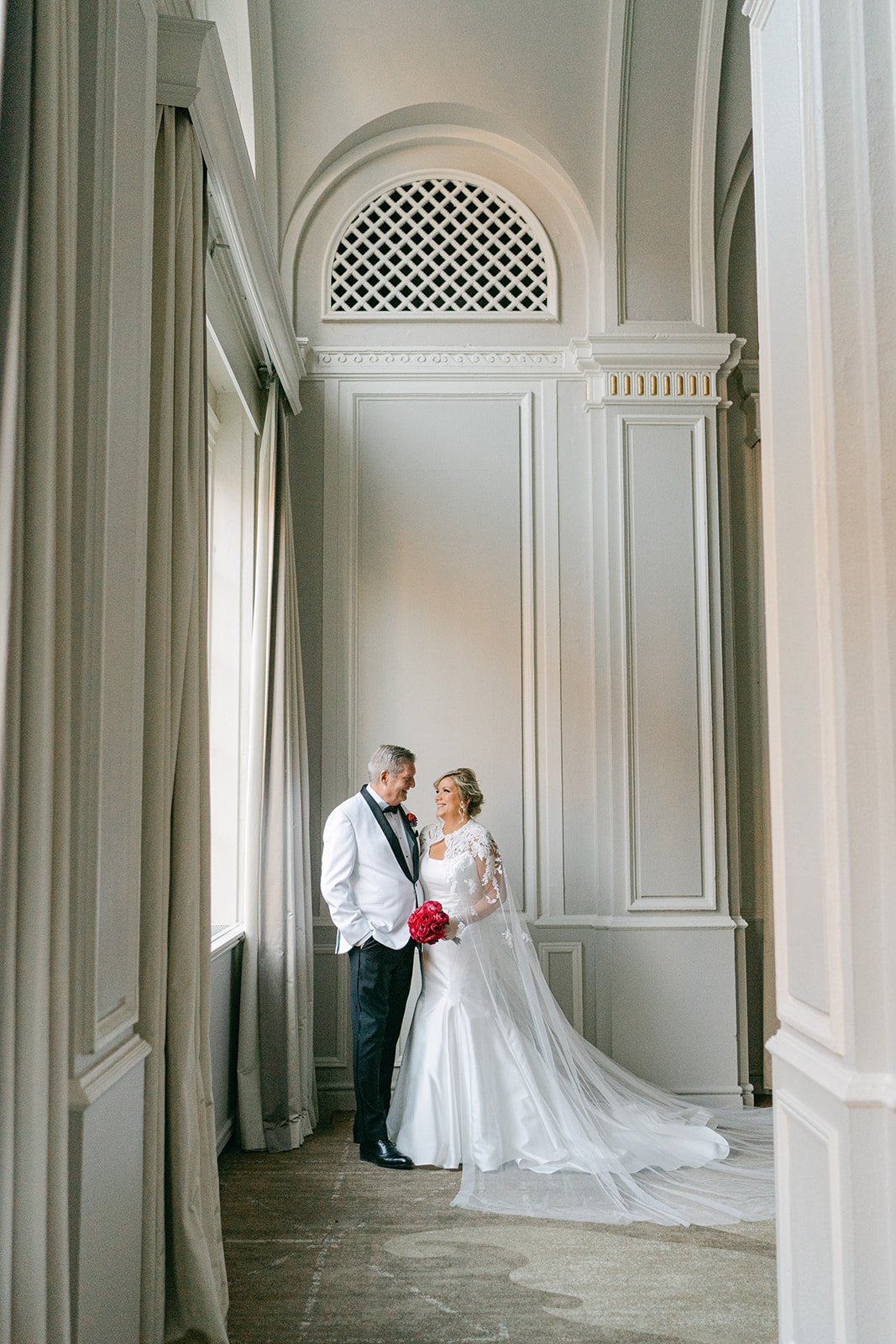 Bride and groom standing in the grand Omni Severin ballroom