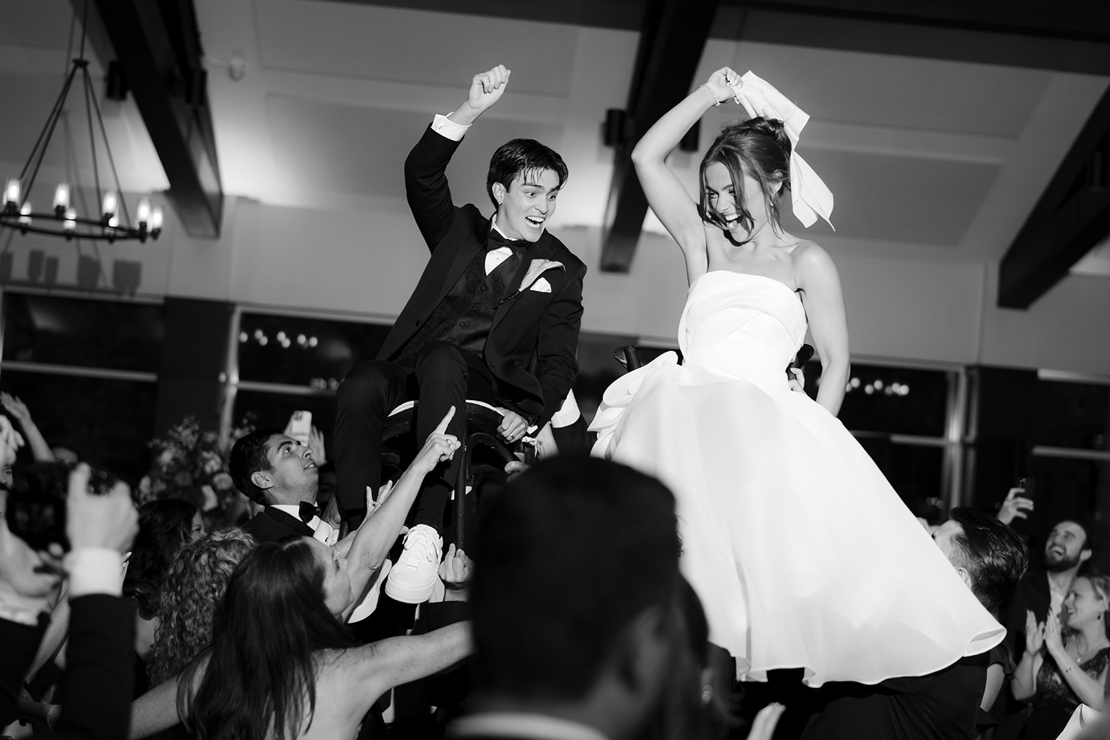 Couple lifted into the air during hora at The Bluffs at Conner Prairie Wedding in Fishers, Indiana